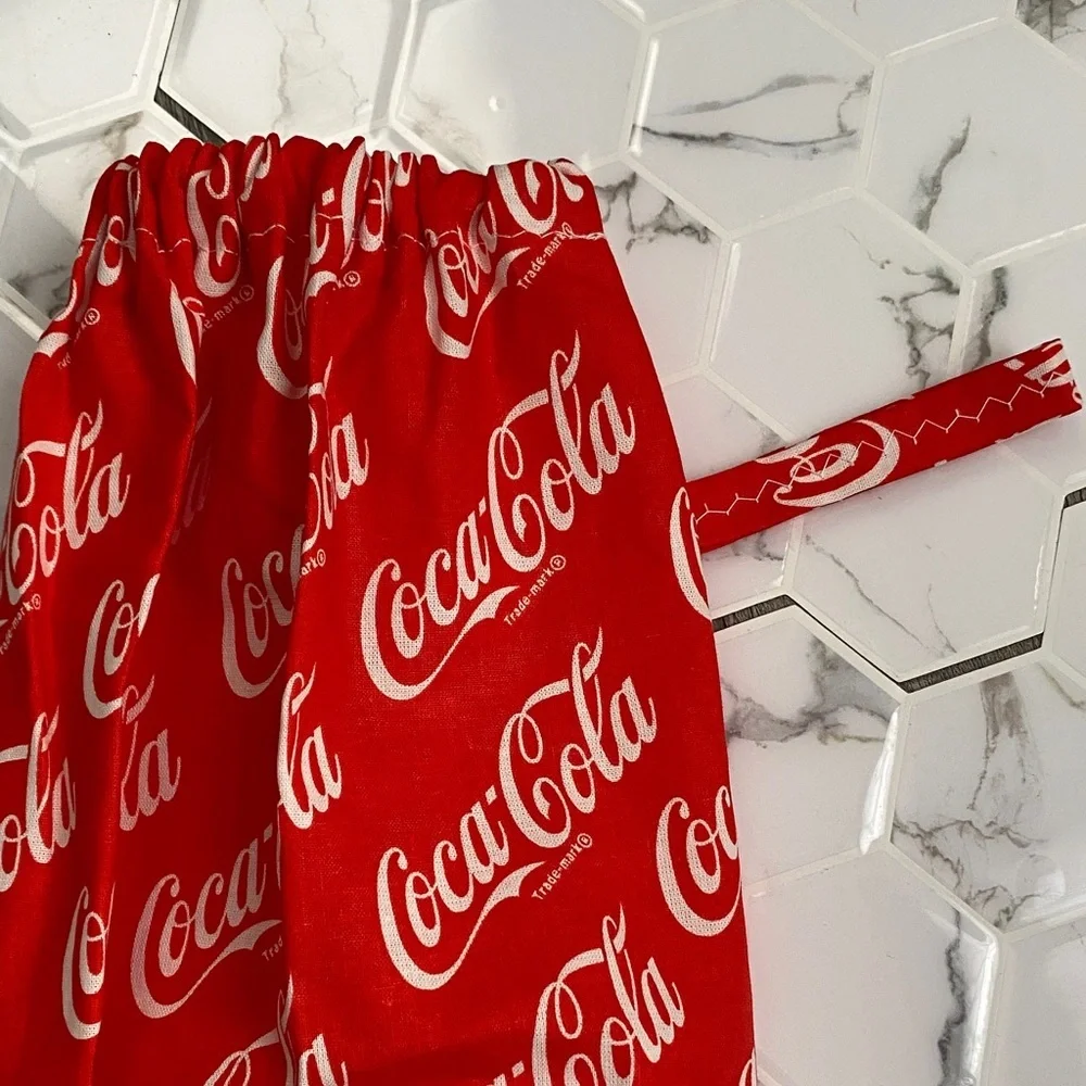 Handmade wall hanging grocery bags organizer and pantry with Coca Cola logo.